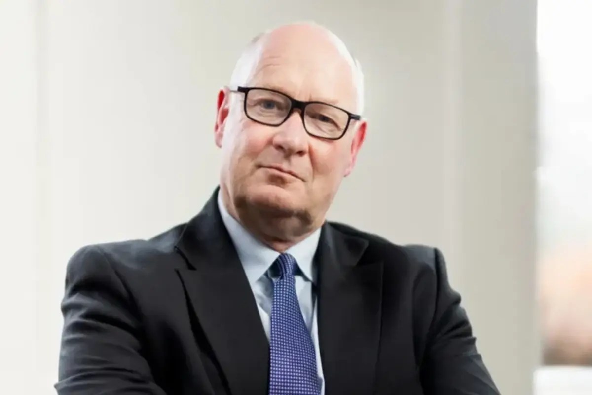 Douglas Flint, prominent business leader, addressing an audience at a corporate event in a formal setting