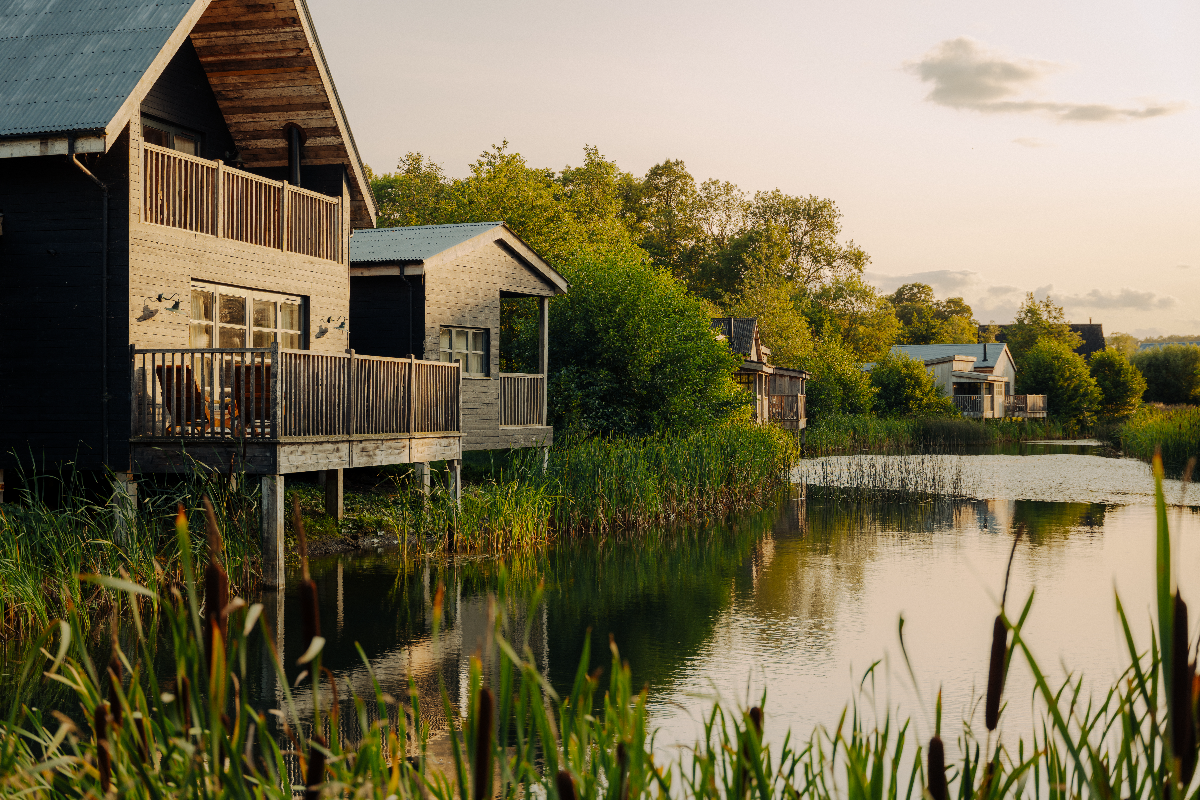 Breaking news event with a crowd gathered at a press conference, microphones set up on a podium, and journalists taking notes