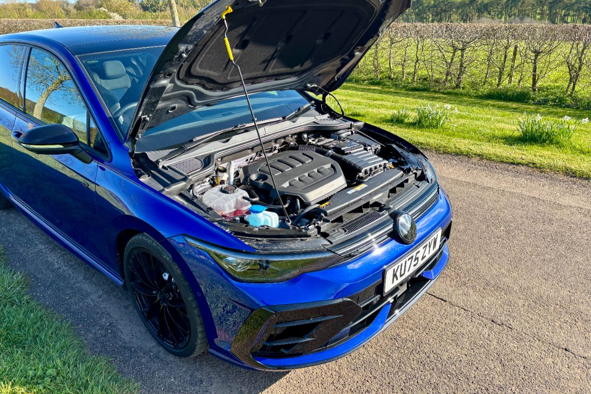 Breaking news event scene with a crowd gathered outside a prominent city building under clear blue skies